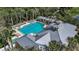 Aerial view showcases a sparkling community pool with lounge seating and mature landscaping at 5548 Simonton St, Bradenton, FL 34203