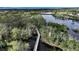 Elevated view of a wooden walking path across a body of water amid lush greenery at 5548 Simonton St, Bradenton, FL 34203