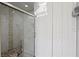 Modern bathroom featuring a glass-enclosed shower, updated fixtures, and a closet at 5670 Rock Dove Dr, Sarasota, FL 34241