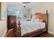 Bedroom features hardwood floors, ceiling fan, and a large window with view at 5670 Rock Dove Dr, Sarasota, FL 34241