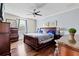 Well-lit bedroom featuring hardwood floors, neutral-colored walls, ceiling fan and tasteful decor at 5670 Rock Dove Dr, Sarasota, FL 34241