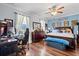 Large bedroom featuring hardwood floors, ceiling fan, and a large window at 5670 Rock Dove Dr, Sarasota, FL 34241