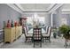 Inviting dining room boasting a glass table, chandelier, and display cabinet at 5670 Rock Dove Dr, Sarasota, FL 34241