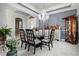 The open dining room features a modern chandelier, glass table, and elegant decor at 5670 Rock Dove Dr, Sarasota, FL 34241