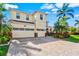 Elegant two-story home featuring a three-car garage and paver driveway at 5670 Rock Dove Dr, Sarasota, FL 34241