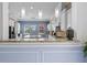 View of the open kitchen featuring white cabinetry, an island with seating, and pendant lighting at 5670 Rock Dove Dr, Sarasota, FL 34241