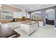 Bright kitchen with an island, white cabinetry, granite countertops, and stainless appliances is ideal for modern living at 5670 Rock Dove Dr, Sarasota, FL 34241