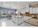 Spacious kitchen features an island, white cabinetry, granite countertops, and a breakfast nook with lots of natural light at 5670 Rock Dove Dr, Sarasota, FL 34241