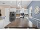 Charming kitchen featuring white cabinetry, a large island with seating, and modern appliances at 5670 Rock Dove Dr, Sarasota, FL 34241