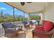 Relax on this lanai with comfortable seating and enjoy the beautiful views through the screened windows at 5670 Rock Dove Dr, Sarasota, FL 34241