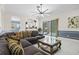 The living room leads to the kitchen and outdoor patio, complete with modern furniture at 5670 Rock Dove Dr, Sarasota, FL 34241