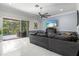 Spacious living room with access to a screened patio and views of the outdoor pool area at 5670 Rock Dove Dr, Sarasota, FL 34241