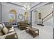 Spacious living area with a chandelier, staircase and natural light that fills the space at 5670 Rock Dove Dr, Sarasota, FL 34241