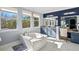 Bright main bathroom featuring a modern tub, vanity, mirrors and decor, and large sunny windows at 5670 Rock Dove Dr, Sarasota, FL 34241