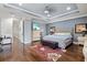 Spacious primary bedroom features a tray ceiling, hardwood floors, and a cozy seating area at 5670 Rock Dove Dr, Sarasota, FL 34241