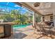 A screened lanai features a pool, dining set, and bar, perfect for outdoor entertaining and relaxation at 5670 Rock Dove Dr, Sarasota, FL 34241