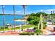 Scenic waterfront view, featuring a beach, boat dock, and tropical landscaping at 5670 Rock Dove Dr, Sarasota, FL 34241