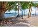 Picturesque waterfront view featuring a swing, bay, and shaded trees in park at 5670 Rock Dove Dr, Sarasota, FL 34241