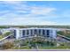 Stunning aerial view of condo complex with water feature, lush landscaping, and parking at 5855 Midnight Pass Rd # 327, Sarasota, FL 34242