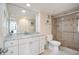 Bathroom featuring a vanity with marble countertops and a glass-enclosed shower at 5855 Midnight Pass Rd # 327, Sarasota, FL 34242