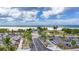Beautiful beach view with white sand, palm trees, blue skies, and ample parking at 5855 Midnight Pass Rd # 327, Sarasota, FL 34242