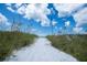 Sandy path through seagrass leading to a beach and ocean at 5855 Midnight Pass Rd # 327, Sarasota, FL 34242