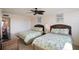 Cozy bedroom featuring two beds with tropical bedding and a ceiling fan at 5855 Midnight Pass Rd # 327, Sarasota, FL 34242