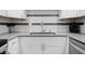 Close-up of kitchen with sleek countertops and tiled backsplash at 5855 Midnight Pass Rd # 327, Sarasota, FL 34242