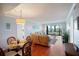 Bright living area with dining space and sliding glass doors to the balcony with city views at 5855 Midnight Pass Rd # 327, Sarasota, FL 34242
