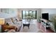 Bright living room featuring comfortable seating and balcony access at 5855 Midnight Pass Rd # 327, Sarasota, FL 34242