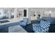 Sitting area in the lobby with several blue upholstered chairs with a geometric pattern and modern decor at 5855 Midnight Pass Rd # 327, Sarasota, FL 34242