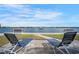 Relaxing waterfront featuring lounge chairs with scenic water views at 5855 Midnight Pass Rd # 327, Sarasota, FL 34242