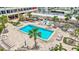 Aerial view of the pool area with lush landscaping and plenty of room to lounge at 6140 Midnight Pass Rd # 103, Sarasota, FL 34242