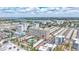 Aerial view of a condo building with a pool and beach access, surrounded by a charming coastal community at 6140 Midnight Pass Rd # 103, Sarasota, FL 34242