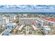 Aerial view of a condo building with a pool and beach access, surrounded by a charming coastal community at 6140 Midnight Pass Rd # 103, Sarasota, FL 34242