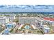 Aerial view of a building and surrounding areas featuring pools, beach, and lush landscaping at 6140 Midnight Pass Rd # 103, Sarasota, FL 34242