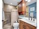 The remodeled bathroom features a walk-in shower with a bench, a modern vanity and updated fixtures at 6140 Midnight Pass Rd # 103, Sarasota, FL 34242