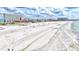 Beautiful beachfront showing a building under a cloudy sky and turquoise water at 6140 Midnight Pass Rd # 103, Sarasota, FL 34242