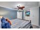 A primary bedroom has a ceiling fan and light and custom cabinetry at 6140 Midnight Pass Rd # 103, Sarasota, FL 34242