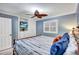 Cozy bedroom with a ceiling fan and built-in shelves for storage at 6140 Midnight Pass Rd # 103, Sarasota, FL 34242
