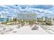 Exterior view of building surrounded by palm trees, cabanas, and access to the beach at 6140 Midnight Pass Rd # 103, Sarasota, FL 34242
