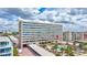 View of the building with a red arrow pointing to the unit, pool in the foreground at 6140 Midnight Pass Rd # 103, Sarasota, FL 34242