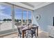 Dining area with a table set for four overlooking the beach at 6140 Midnight Pass Rd # 103, Sarasota, FL 34242