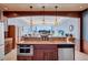 Kitchen island with breakfast bar and views of the living area and balcony with ocean view at 6140 Midnight Pass Rd # 103, Sarasota, FL 34242