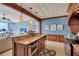 A spacious kitchen offers an island and breakfast bar, plus views of the living room and beach through large windows at 6140 Midnight Pass Rd # 103, Sarasota, FL 34242