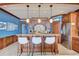 Well-appointed kitchen features custom cabinetry and a breakfast bar seating three at 6140 Midnight Pass Rd # 103, Sarasota, FL 34242