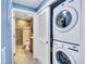 A closet offers a stacked washer and dryer off the bathroom at 6140 Midnight Pass Rd # 103, Sarasota, FL 34242