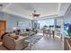 Bright living room with ocean view, comfortable seating, and adjacent dining area at 6140 Midnight Pass Rd # 103, Sarasota, FL 34242