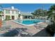 Inviting community pool with lounge chairs, tables, shade and beautiful landscaping at 6140 Midnight Pass Rd # 103, Sarasota, FL 34242