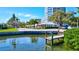 Waterfront dock, lush green vegetation, and neighborhood views at 6140 Midnight Pass Rd # 103, Sarasota, FL 34242